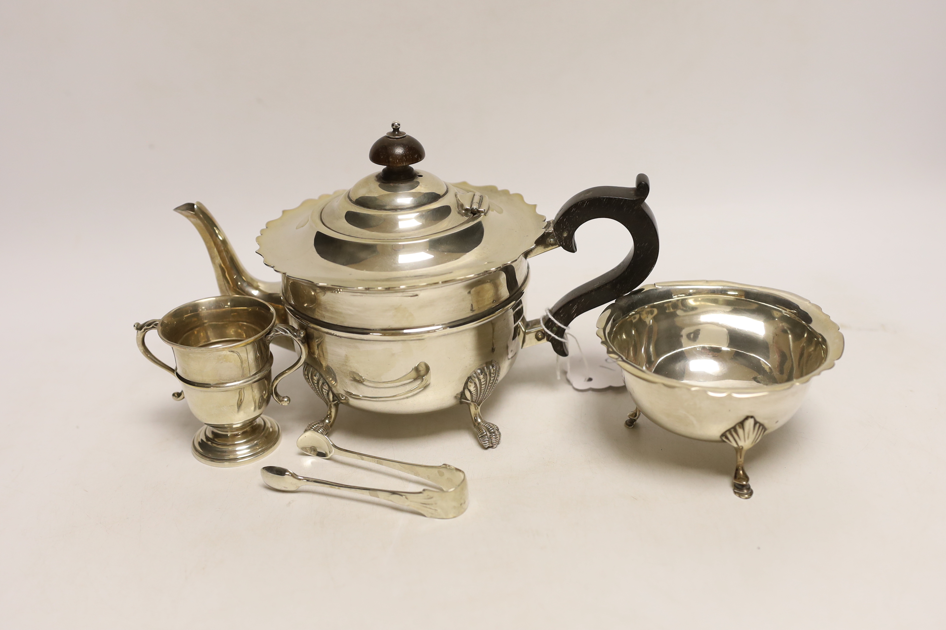 A George V silver teapot, J. Sherwood & Sons, Birmingham, 1913, an Irish silver sugar bowl pair of silver sugar tongs and a small silver two handled trophy cup, gross 18.7oz.